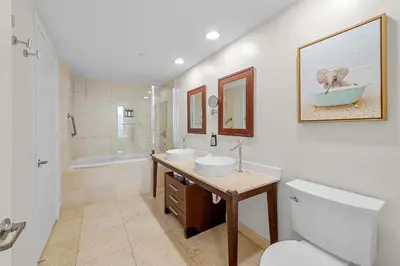 a bathroom with two sinks and a toilet and a shower at Luxury Waterfront W Hotel Condo Brickell Skyline Views in Miami