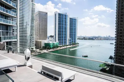 a balcony with a view of a river and buildings at Brickell 35th Floor Residence with Saltwater Pool 5-Star Amenities in Miami