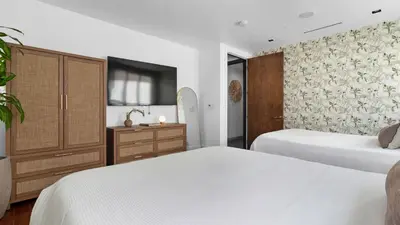 a bedroom with two beds and a dresser at Jungle Penthouse Private Pool in South Beach in Miami Beach