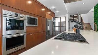a kitchen with a stove and a counter top at Jungle Penthouse Private Pool in South Beach in Miami Beach