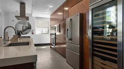 a kitchen with a sink and a refrigerator at Jungle Penthouse Private Pool in South Beach in Miami Beach