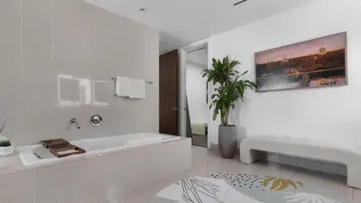 a white bathroom with a tub and a plant at Jungle Penthouse Private Pool in South Beach in Miami Beach