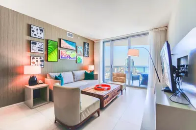 a living room with a couch and a table at Luxury Condo with Beach Access in Hollywood