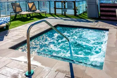 a hot tub with a metal rail in a building at Luxury Condo with Beach Access in Hollywood