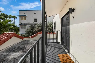 a balcony with a black door on a building at Art Deco Gem by the Beach King Bed & Parking in Miami Beach