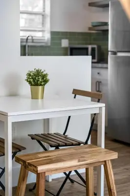a white table and chairs in a kitchen at Art Deco Gem Steps to Beach in Miami Beach