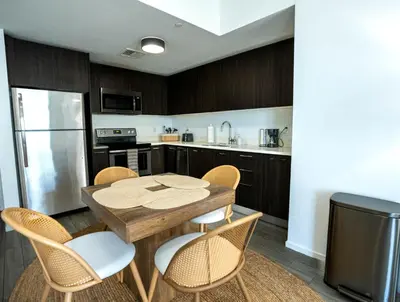 a kitchen with a wooden table and chairs at Downtown Miami 2BR Retreat - Walk to Bayside & Port - Sleeps 6 in Miami