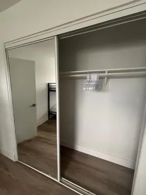 a sliding glass door in a room with a mirror at CG Miami House in Miami