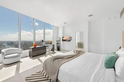 a white bedroom with a large bed and a desk at Hyde Dream Penthouse in Hollywood