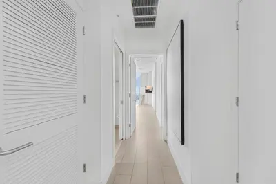 a hallway in a house with white walls and a mirror at Hyde Dream Penthouse in Hollywood