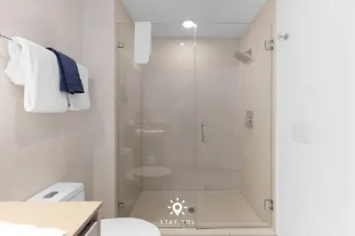 a shower with a glass door in a bathroom at Oceanline 3BR Corner Balcony & Calm Seas in Hollywood