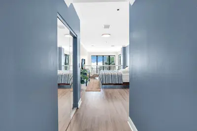 a hallway with a bedroom and a bed in a room at Beachfront Apartment in Miami Beach at the Casablanca Hotel in Miami Beach