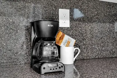 a coffee maker and a cup on a counter at Beachfront Apartment in Miami Beach at the Casablanca Hotel in Miami Beach