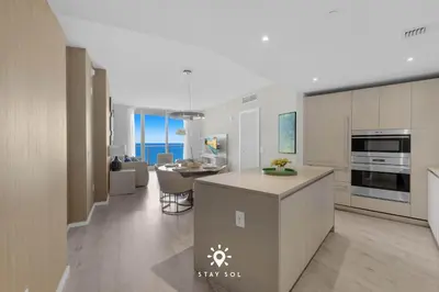 a kitchen and living room with a view of the ocean at Insane Ocean View Balcony - Beachfront Resort & Pool in Hollywood
