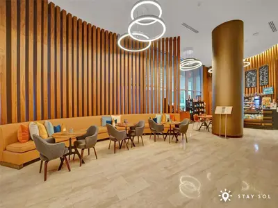 a lobby with a couch and tables and chairs at Insane Ocean View Balcony - Beachfront Resort & Pool in Hollywood