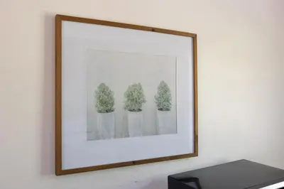 a framed picture of three plants on a wall at B08 10 MIN FROM MIAMI BEACH, Studio, Miami Design District & Wynwood in Miami