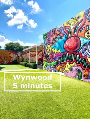 a building covered in graffiti with the words wynwood minutes at B08 10 MIN FROM MIAMI BEACH, Studio, Miami Design District & Wynwood in Miami