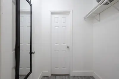 a hallway with a white door and a mirror at B08 10 MIN FROM MIAMI BEACH, Studio, Miami Design District & Wynwood in Miami