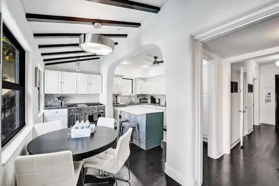 a kitchen with a round table and white chairs at Spanish 5 Bedroom Pool House Minutes to the Beach in Hollywood