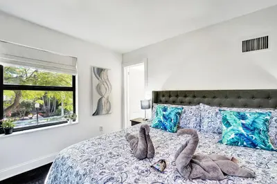 a bedroom with a bed with two animals on it at Spanish 5 Bedroom Pool House Minutes to the Beach in Hollywood