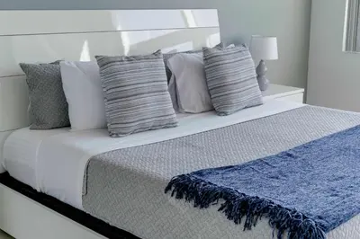 a bedroom with a bed with pillows on it at Midtown Miami Marvel- Heated Pool & Prime Location in Miami