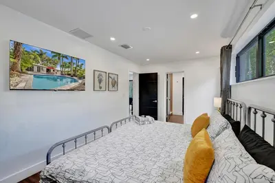a bedroom with a bed and a couch at Cute 3 Bedroom 2 Bathroom Pool Home in Hollywood