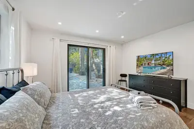 a bedroom with a large bed and a large window at Cute 3 Bedroom 2 Bathroom Pool Home in Hollywood