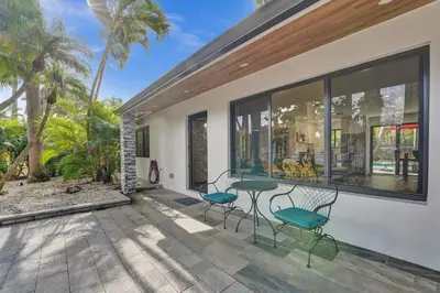 a patio with a table and chairs on a house at Cute 3 Bedroom 2 Bathroom Pool Home in Hollywood
