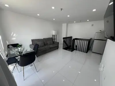 a living room with a couch and a table at The Azure Terrace Loft in Miami Beach