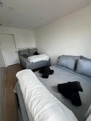 a room with two beds and a couch at The Azure Terrace Loft in Miami Beach