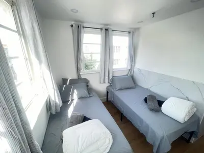 a room with two beds and two windows at The Azure Terrace Loft in Miami Beach