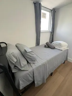 a small bed in a room with a window at The Azure Terrace Loft in Miami Beach