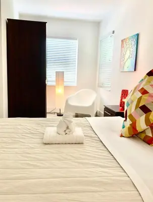 a bedroom with a bed with a towel on it at B10 7 MIN FROM MIAMI BEACH, 1 Bed Apartment, Design District & Wynwood in Miami