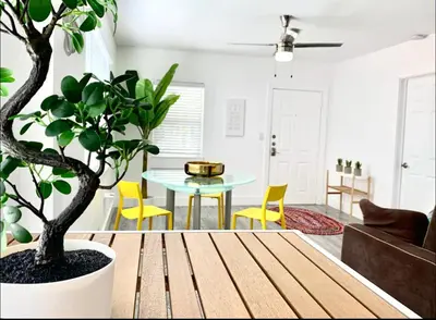 a living room with a table and a potted plant at B10 7 MIN FROM MIAMI BEACH, 1 Bed Apartment, Design District & Wynwood in Miami
