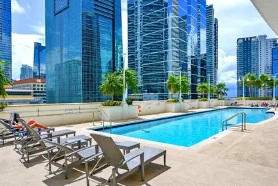 a swimming pool on the roof of a building with tall buildings at Stylish Condo with Panoramic Ocean Views in Miami