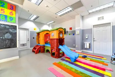 a childs play room with a slide and a playground at Stylish Condo with Panoramic Ocean Views in Miami