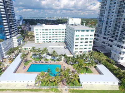 an aerial view of a building with a pool and palm trees at Ocean Front Resort Studio in Miami Beach