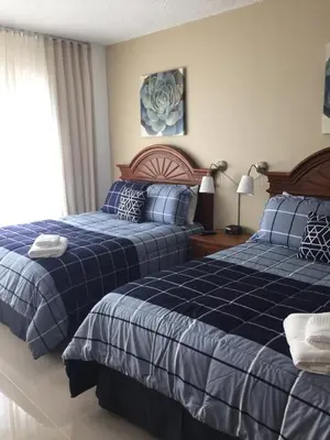 a bedroom with two beds and a window at Ocean Front Resort Studio in Miami Beach