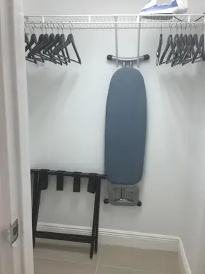 a closet with a blue chair in a room at Ocean Front Resort Studio in Miami Beach