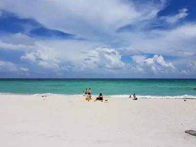 a group of people on a beach near the ocean at Ocean Front Resort Studio in Miami Beach
