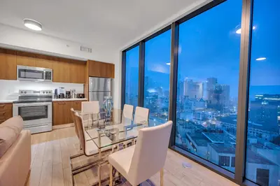 a kitchen and dining room with a view of the city at Amazing property in Miami