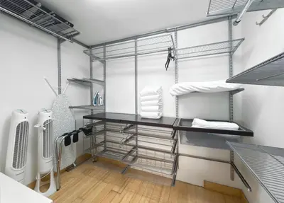 a walk in closet with metal shelves and a desk at Newly Renovated 1BR Brickell Condo plus Parking in Miami
