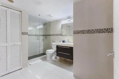 a bathroom with a toilet and a sink and a shower at Newly Renovated 1BR Brickell Condo plus Parking in Miami