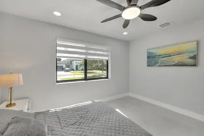 a bedroom with a ceiling fan and a window at NEW house in Miami Casa Calle 19 in Miami