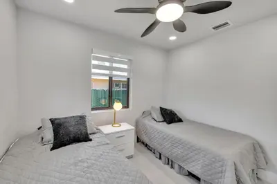 a bedroom with two beds and a ceiling fan at NEW house in Miami Casa Calle 19 in Miami
