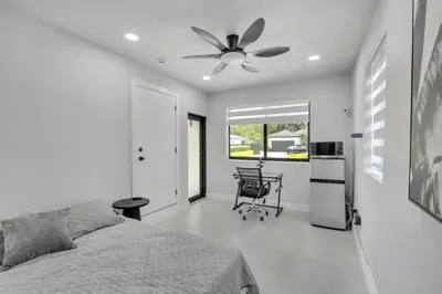 a bedroom with a bed and a ceiling fan at NEW house in Miami Casa Calle 19 in Miami