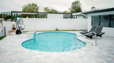 a swimming pool in the middle of a yard at Bimini Bliss Waterfront Pool Retreat in Fort Lauderdale