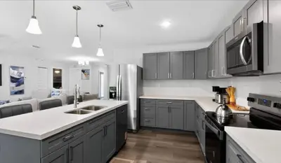 a kitchen with gray cabinets and white counter tops at New 3BR in Central Miami Location for Family & Groups in Miami