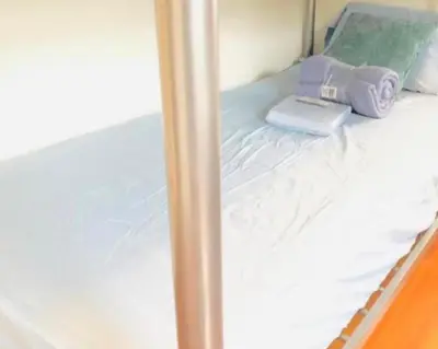 a close up of a bed in a room at Men Only Hostel Fort Lauderdale Airport Long Term OK in Fort Lauderdale