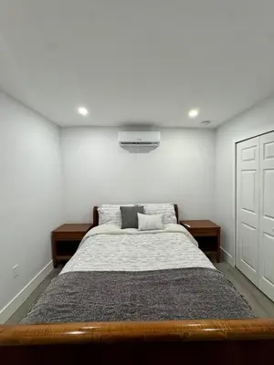 a bedroom with a large bed with two pillows at Elegant Miami South Stay! in Cutler Bay